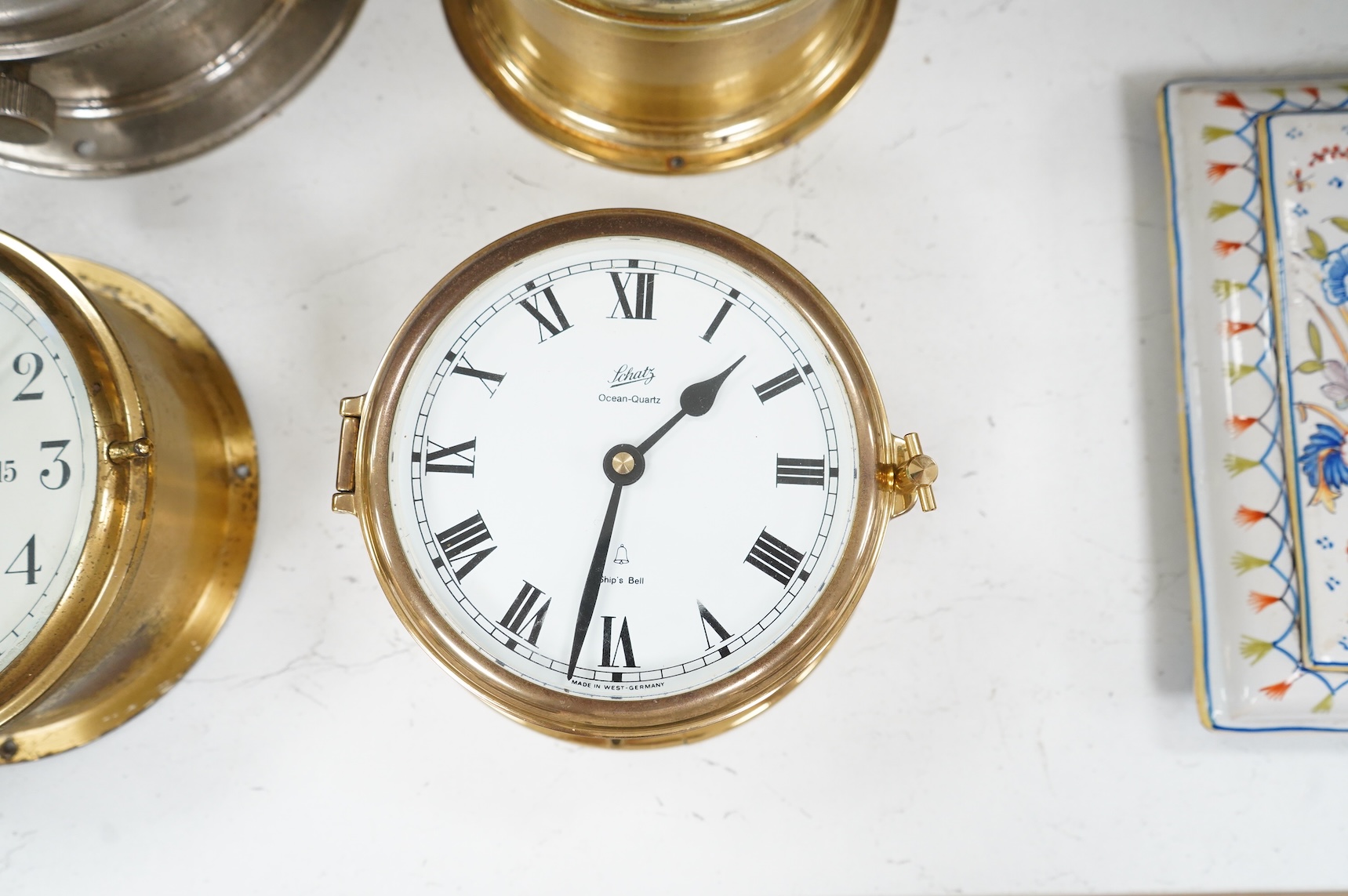 A ship's clock by Story of Barrow, a CCCP ship's clock and four other brass examples, some with keys, largest 28cm in diameter